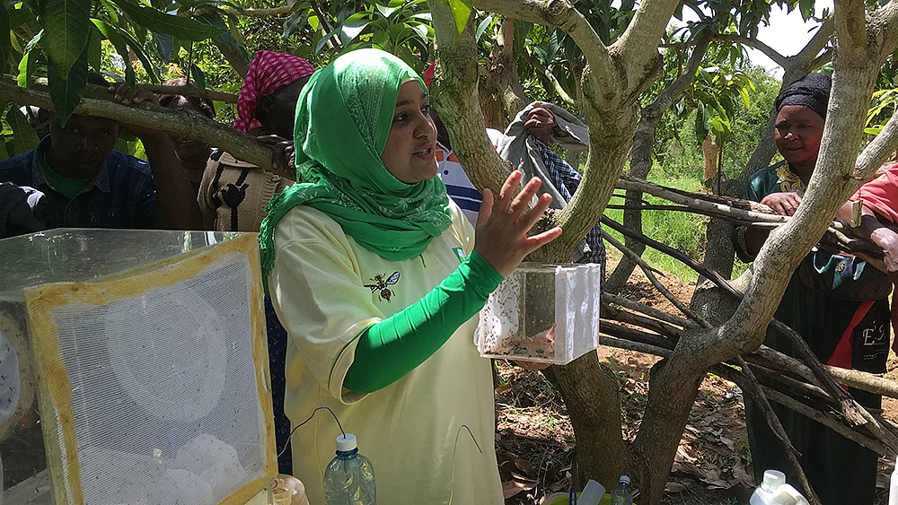 Dr. Khamis doing her research in the field with the people.